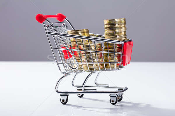 Stock photo: Shopping Cart Filled With Stacked Coins