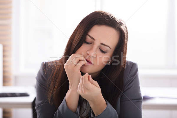 Businesswoman Biting Her Finger Nails Stock photo © AndreyPopov