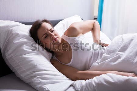 Foto stock: Mujer · sufrimiento · dolor · de · espalda · cama · madera