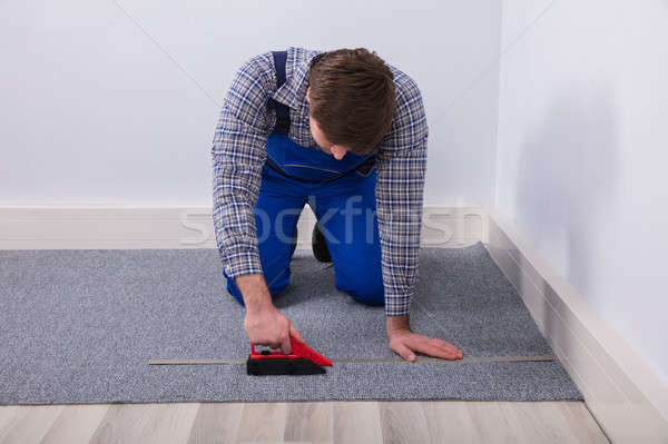 Carpet Fitter Installing Carpet With Wireless Screwdriver Stock photo © AndreyPopov