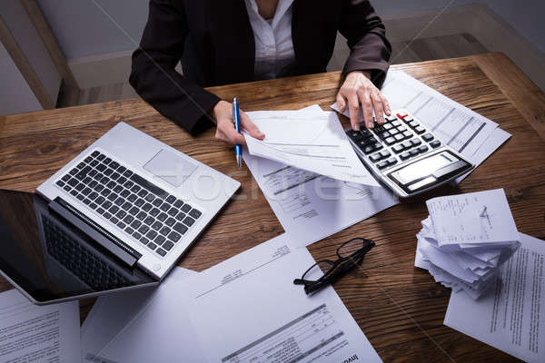 Businessperson Calculating Invoice Stock photo © AndreyPopov