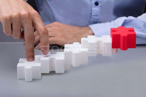 Emberi ujj kirakós játék közelkép fehér pénz Stock fotó © AndreyPopov