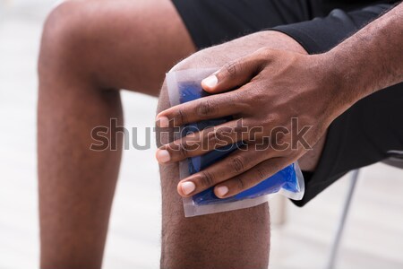 Man Applying Ice Gel Pack On His Knee Stock photo © AndreyPopov