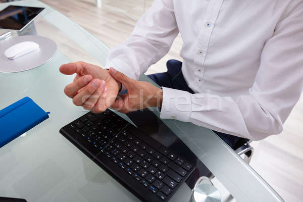 Businessman Holding Painful Wrist Stock photo © AndreyPopov