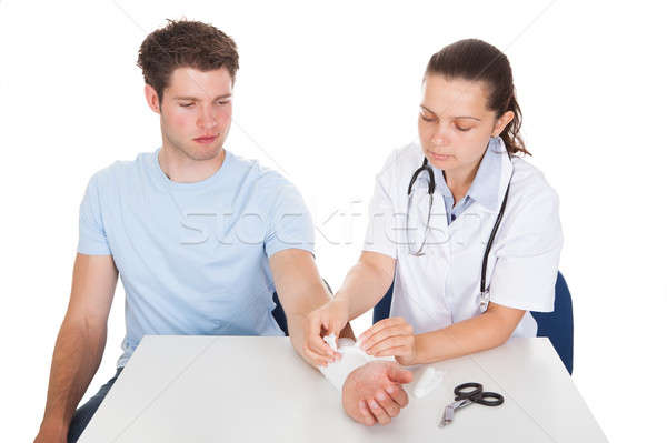 Doctor Bandaging Patient Stock photo © AndreyPopov