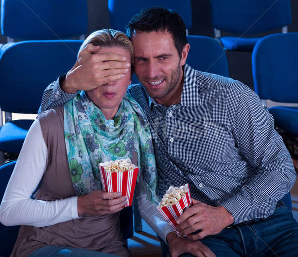 Couple watching a movie reacting in horror Stock photo © AndreyPopov
