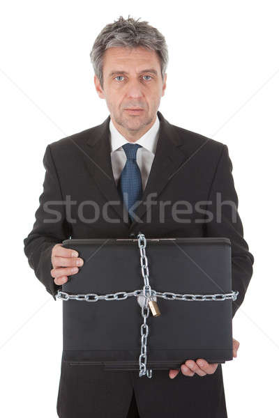 Businessman holding laptop with chain and lock Stock photo © AndreyPopov