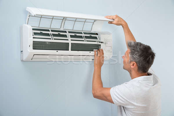 Man Cleaning Air Conditioning System Stock photo © AndreyPopov