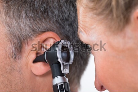 Doctor Examining Patient's Hair Through Dermatoscope Stock photo © AndreyPopov