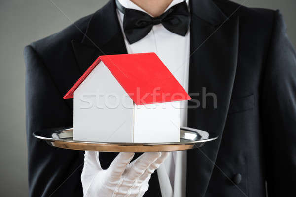 Midsection Of Waiter Holding House Model In Tray Stock photo © AndreyPopov