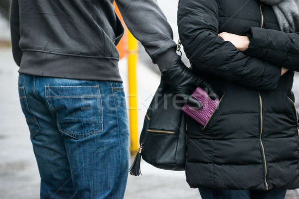 Robber Stealing Clutch From Woman's Jacket On Street Stock photo © AndreyPopov