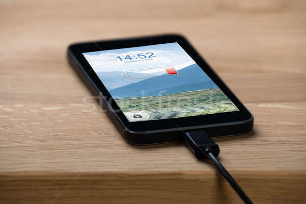 Closeup Of Smart Phone Connected To Charger Stock photo © AndreyPopov