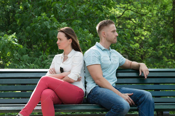 Couple Sitting Back To Back On Bench Stock photo © AndreyPopov