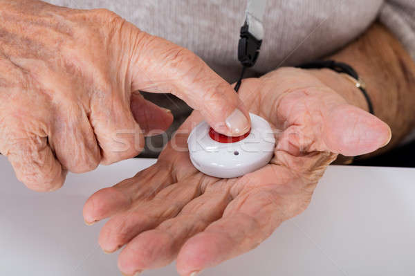 Senior Woman Pressing Alarm Button Stock photo © AndreyPopov