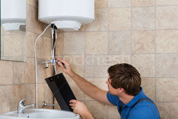 Plumber Checking Electric Boiler Stock photo © AndreyPopov