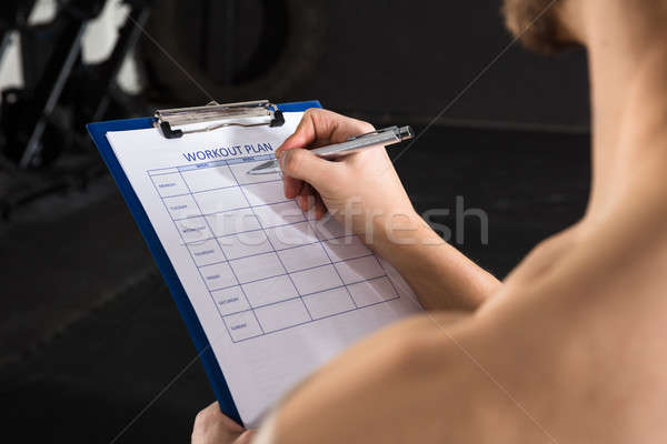 Close-up Of A Person Hand Writing A Workout Plan Stock photo © AndreyPopov