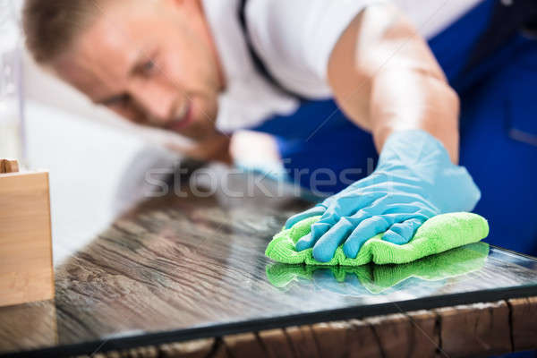 Close-up Of A Janitor Cleaning Desk With Cloth Stock photo © AndreyPopov