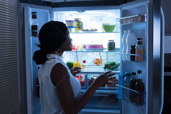 Woman Taking Out Bottle From Refrigerator Stock photo © AndreyPopov