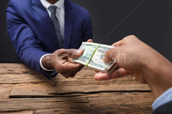 Businessperson Taking Bribe From Partner Stock photo © AndreyPopov
