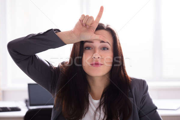 Zakenvrouw tonen verliezer teken vingers voorhoofd Stockfoto © AndreyPopov