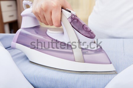 Woman Ironing Cloth On Ironing Board Stock photo © AndreyPopov