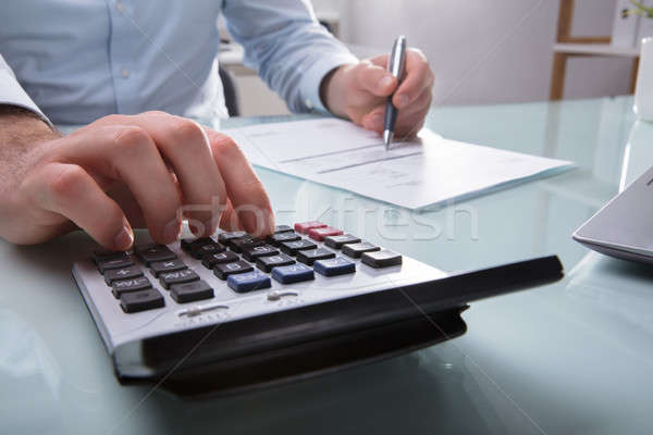 Businessperson Calculating Invoice Stock photo © AndreyPopov