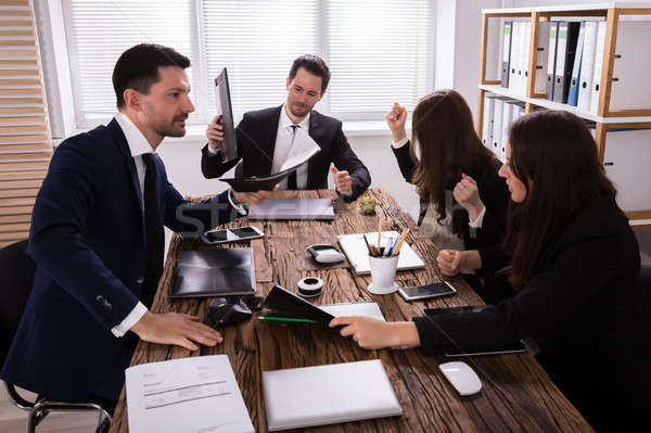 Stock photo: Businesspeople Blaming Depressed Male Colleague