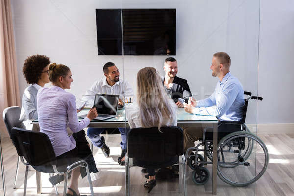 Disabled Manager Sitting With His Colleagues Stock photo © AndreyPopov