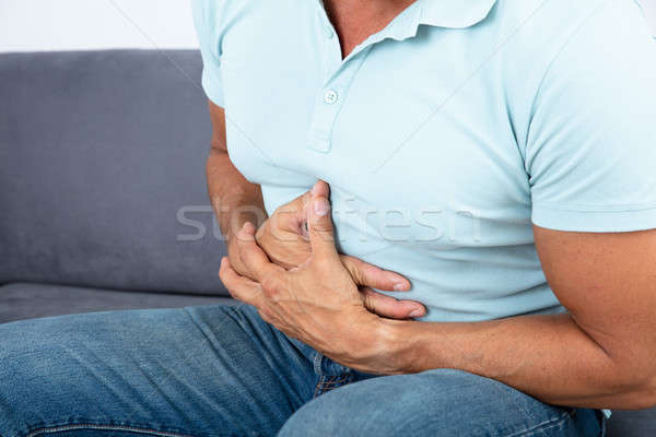 Primer plano hombre dolor estómago mano alimentos Foto stock © AndreyPopov