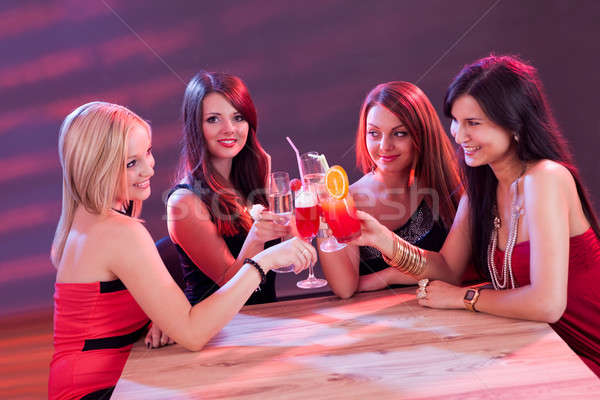 Stock photo: Female friends enjoying a cocktail
