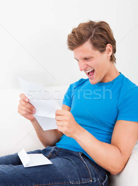 Happy Man Looking At Paper Stock photo © AndreyPopov