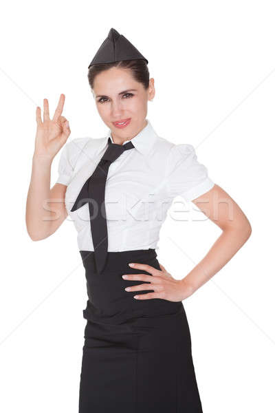 Stewardess making Ok hand gesture Stock photo © AndreyPopov