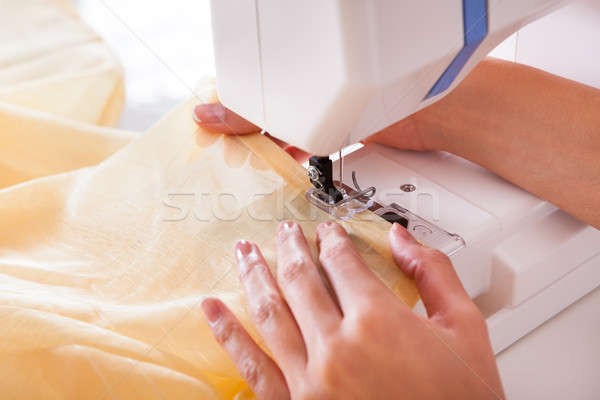 Woman working with her sewing machine Stock photo © AndreyPopov