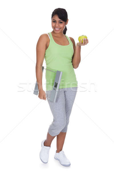 Portrait Of Woman Holding A Weighing Scale And An Apple Stock photo © AndreyPopov
