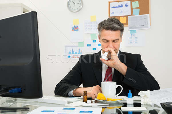 Businessman Spraying Nasal Spray In His Nose Stock photo © AndreyPopov