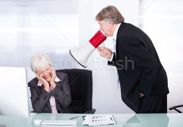 Man Yelling With Megaphone On Woman Stock photo © AndreyPopov