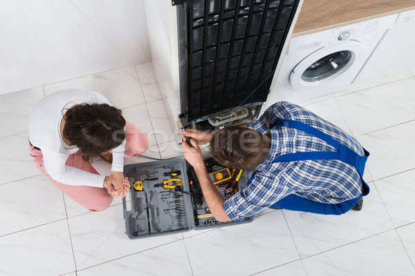 Repairman Repairing Refrigerator Stock photo © AndreyPopov