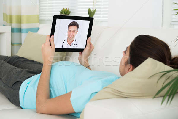 Donna incinta video medico di sesso maschile giovani home Foto d'archivio © AndreyPopov