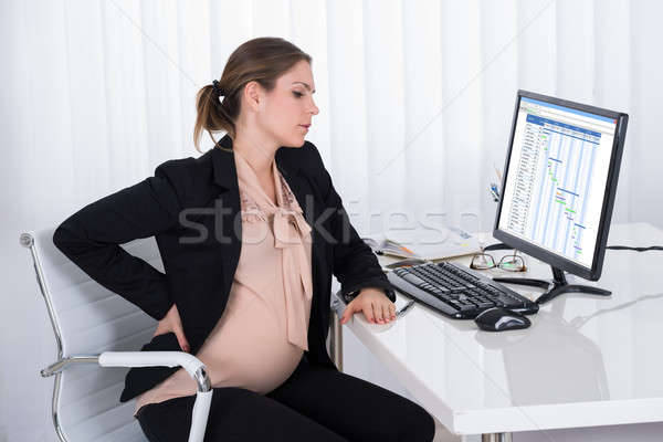 Ciąży kobieta interesu ból w krzyżu biuro pracy komputera Zdjęcia stock © AndreyPopov