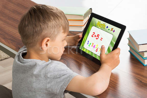 Stock photo: Pupil Solving Math Problem On Digital Tablet