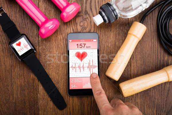 Person Checking Heart Rate Application On Mobilephone Stock photo © AndreyPopov