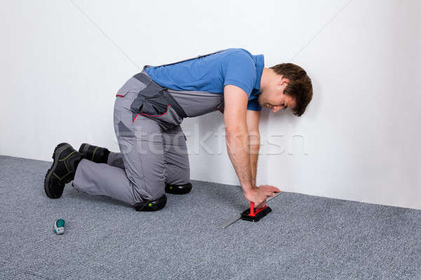 Stock photo: Worker In Overall Lying Carpet