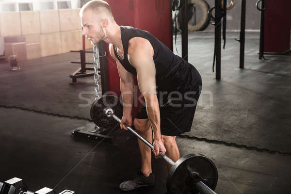 Mann Heben Langhantel Porträt junger Mann Fitnessstudio Stock foto © AndreyPopov