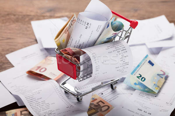 Shopping Cart Filled With Receipts And Money Stock photo © AndreyPopov