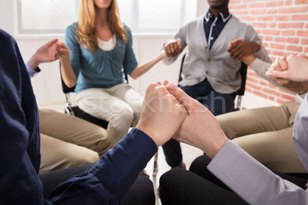 Stock photo: People Holding Each Others Hand Praying Together