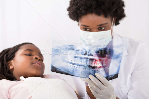 Dentists And Patient Looking At Patient's X-ray Stock photo © AndreyPopov