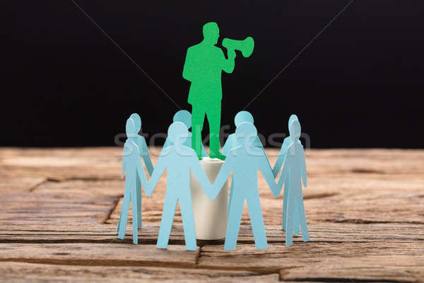 Businessman Speaking Through Megaphone Surrounded By Team Stock photo © AndreyPopov
