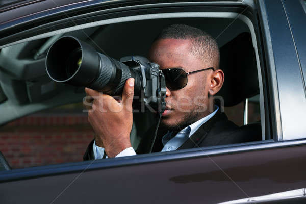 Detective Sitting Inside Car Photographing Stock photo © AndreyPopov