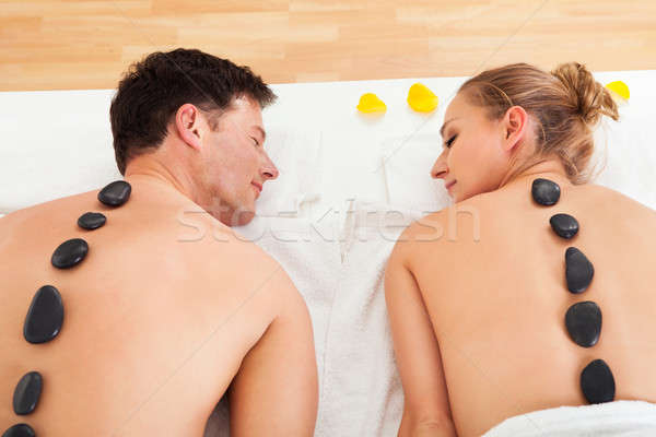 Couple enjoying a hot stone massage Stock photo © AndreyPopov