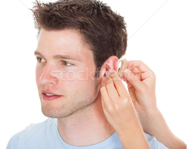 Personne prothèse auditive main aider jeune homme Photo stock © AndreyPopov